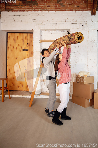 Image of New property owners, young couple moving to new home, apartment, look happy