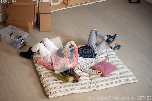 Image of New property owners, young couple moving to new home, apartment, look happy