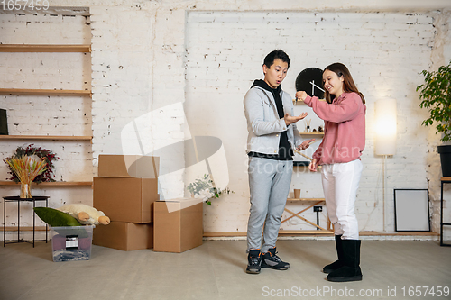 Image of New property owners, young couple moving to new home, apartment, look happy