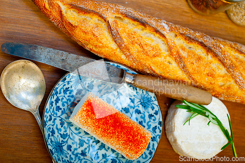 Image of French cheese and fresh  baguette on a wood cutter