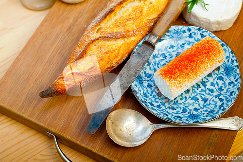 Image of French cheese and fresh  baguette on a wood cutter