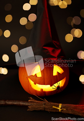 Image of halloween jack-o-lantern in witch's hat and broom