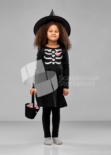 Image of girl with candies trick-or-treating on halloween