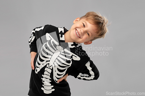 Image of boy in black halloween costume with skeleton bones