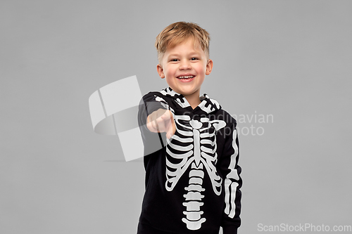 Image of boy in costume of skeleton pointing to camera