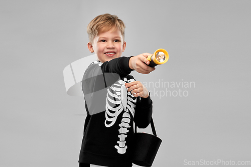 Image of boy with candies and flashlight on halloween