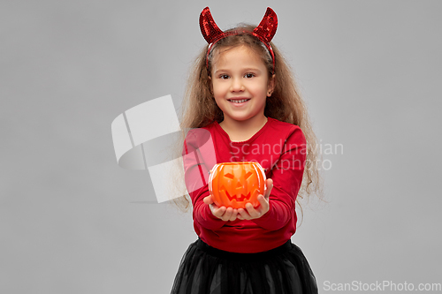 Image of girl in halloween costume with jack-o-lantern