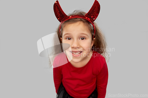 Image of girl in halloween costume and devil's horns