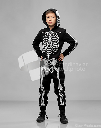 Image of boy in black halloween costume with skeleton bones