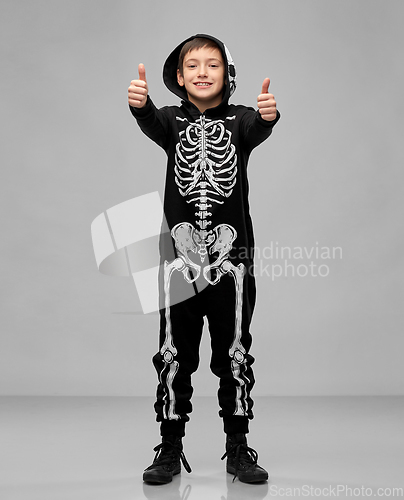 Image of boy in costume of skeleton showing thumbs up