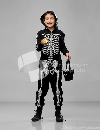 Image of boy with candies and flashlight on halloween