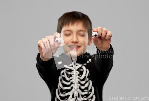 Image of boy in halloween costume with eyeball candies