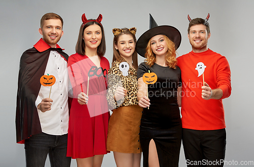 Image of friends in halloween costumes with party props