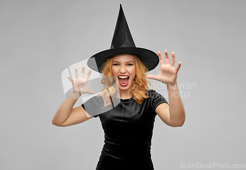 Image of scary woman in black halloween costume of witch