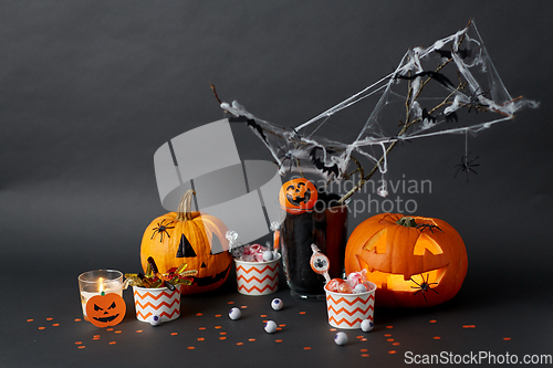 Image of pumpkins, candies and halloween decorations