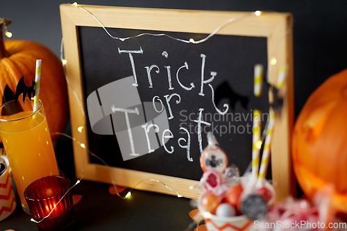 Image of pumpkins, candies and halloween decorations