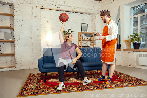 Image of Gender stereotypes. Wife and husband doing things unusual for their genders in social meanings