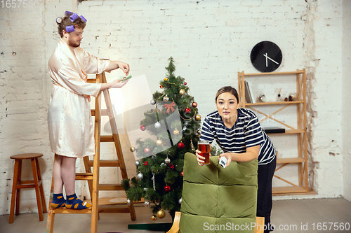 Image of Gender stereotypes. Wife and husband doing things unusual for their genders in social meanings