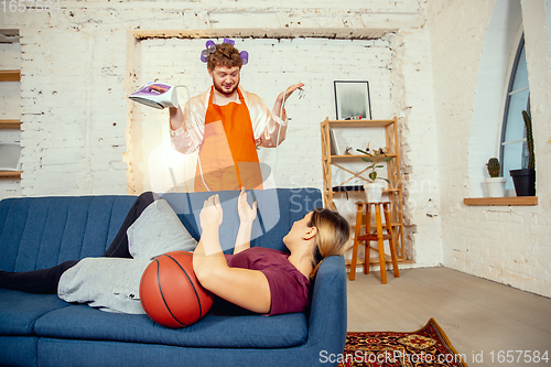 Image of Gender stereotypes. Wife and husband doing things unusual for their genders in social meanings