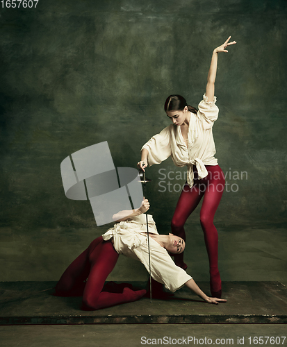 Image of Two young female ballet dancers like duelists with swords. Ballet and contemporary choreography concept. Creative art photo.