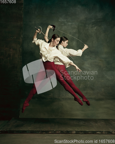 Image of Two young female ballet dancers like duelists with swords. Ballet and contemporary choreography concept. Creative art photo.