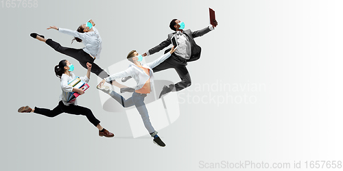 Image of Happy office workers in face masks jumping and dancing in casual clothes or suit isolated on studio background. Creative collage.