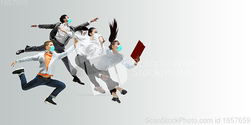 Image of Happy office workers in face masks jumping and dancing in casual clothes or suit isolated on studio background. Creative collage.