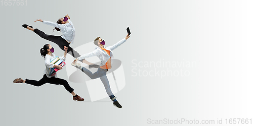 Image of Happy office workers in face masks jumping and dancing in casual clothes or suit isolated on studio background. Creative collage.