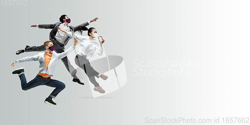 Image of Happy office workers in face masks jumping and dancing in casual clothes or suit isolated on studio background. Creative collage.