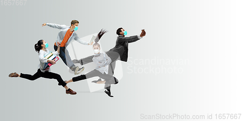 Image of Happy office workers in face masks jumping and dancing in casual clothes or suit isolated on studio background. Creative collage.