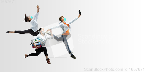 Image of Happy office workers in face masks jumping and dancing in casual clothes or suit isolated on studio background. Creative collage.