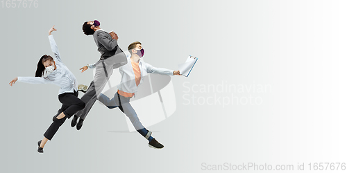 Image of Happy office workers in face masks jumping and dancing in casual clothes or suit isolated on studio background. Creative collage.