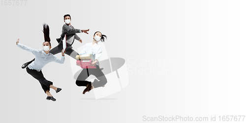 Image of Happy office workers in face masks jumping and dancing in casual clothes or suit isolated on studio background. Creative collage.