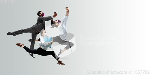 Image of Happy office workers in face masks jumping and dancing in casual clothes or suit isolated on studio background. Creative collage.