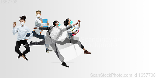 Image of Happy office workers in face masks jumping and dancing in casual clothes or suit isolated on studio background. Creative collage.