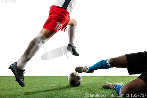 Image of Close up legs of professional soccer, football players fighting for ball on field isolated on white background