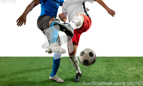 Image of Close up legs of professional soccer, football players fighting for ball on field isolated on white background