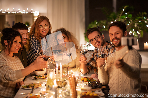 Image of friends taking selfie at christmas dinner party