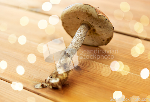 Image of brown cap boletus mushrooms on wooden background