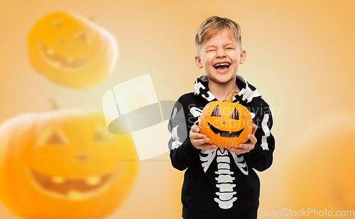 Image of happy boy in halloween costume with jack-o-lantern