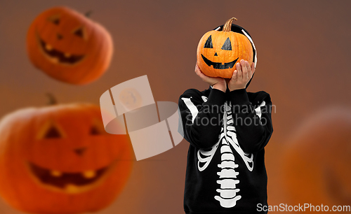 Image of boy in halloween costume with jack-o-lantern