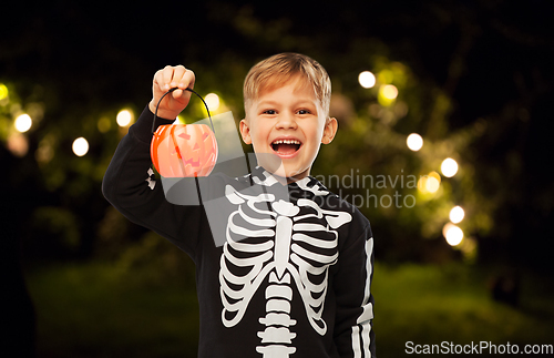 Image of happy boy in halloween costume with jack-o-lantern