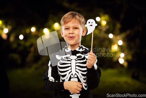 Image of boy in halloween costume with ghost decoration