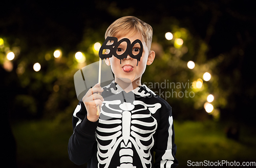 Image of boy in halloween costume of skeleton making faces