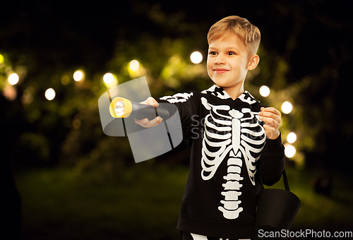 Image of happy with candies and flashlight on halloween