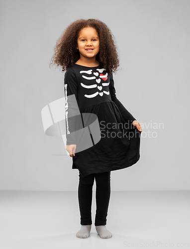 Image of girl in black halloween dress with skeleton bones