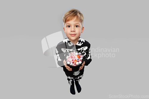 Image of boy with candies trick-or-treating on halloween