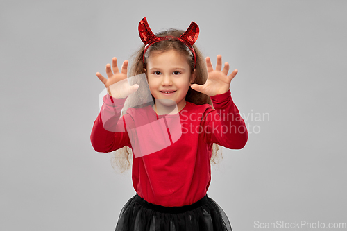 Image of girl costume with devil's horns on halloween