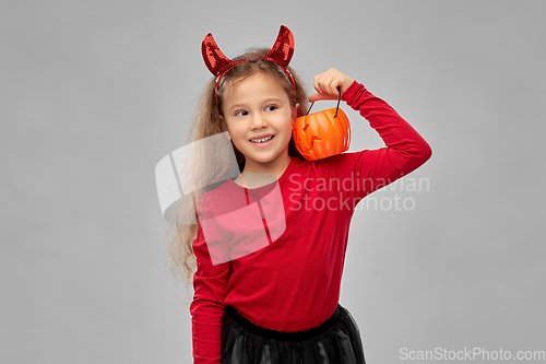 Image of girl in halloween costume with jack-o-lantern