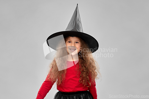Image of happy girl in black witch hat on halloween